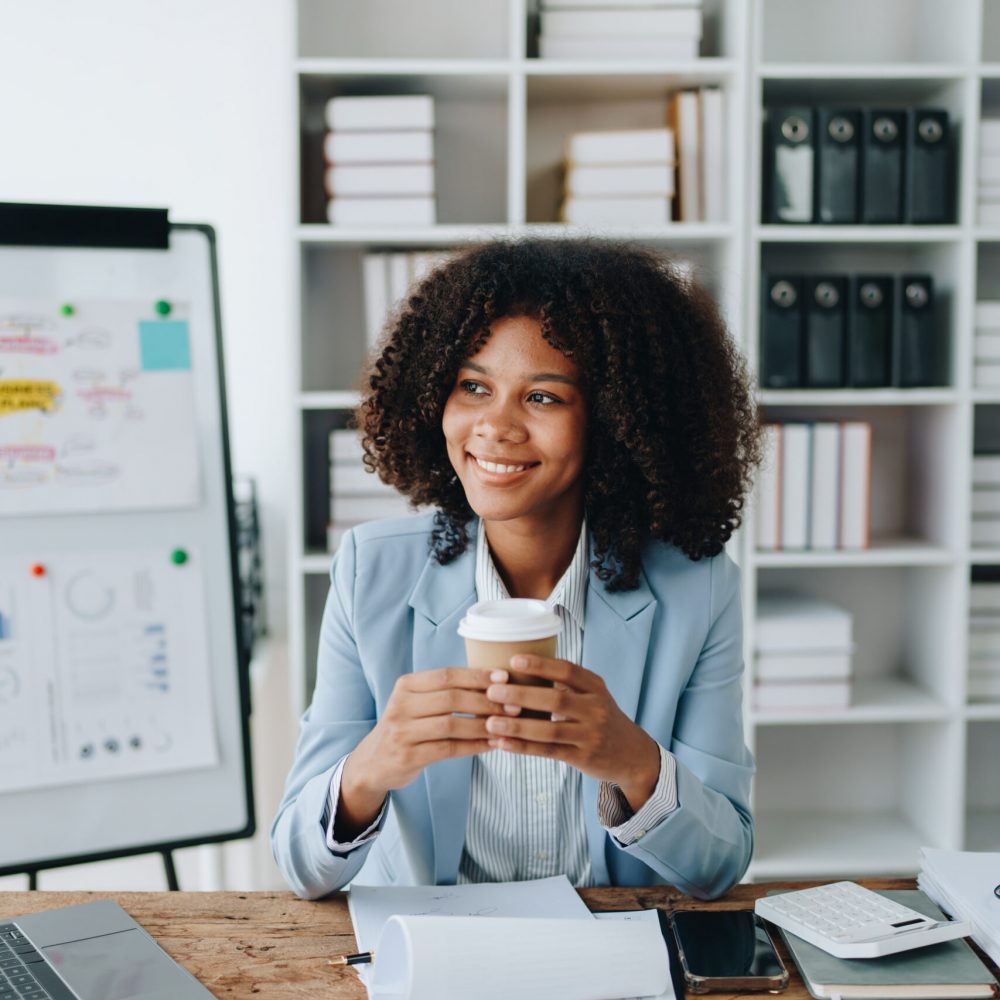 American African business woman using document, computer laptop, calculator, paperwork, documents, in winner and smiling Happy to be successful achievement success. finance and investment concepts.